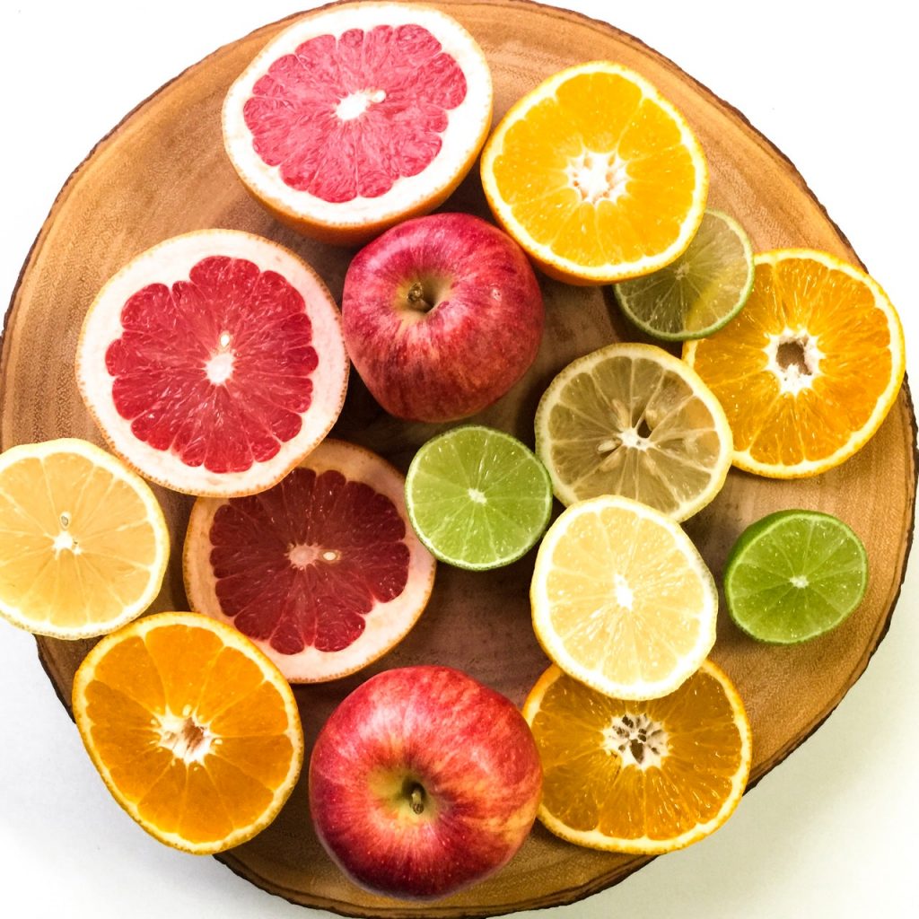 A Plate of chopped Apples, Limes, Lemons, Oranges, and Grapefruit